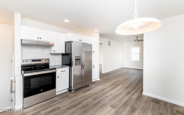 kitchen with white cabinetry, hardwood / wood-style flooring, tasteful backsplash, and appliances with stainless steel finishes