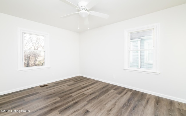 unfurnished room featuring dark hardwood / wood-style floors and ceiling fan