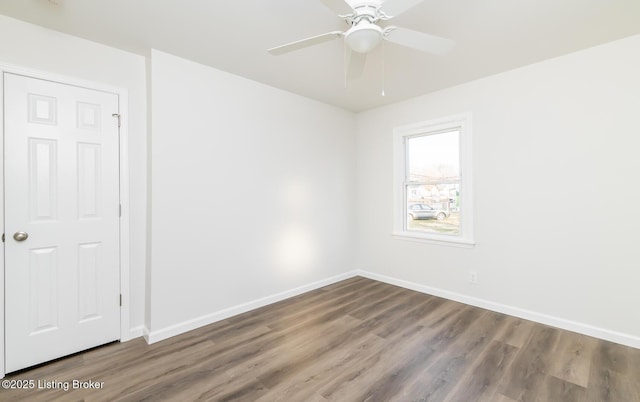 spare room featuring hardwood / wood-style floors and ceiling fan