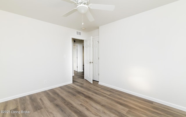 spare room featuring ceiling fan and dark hardwood / wood-style floors