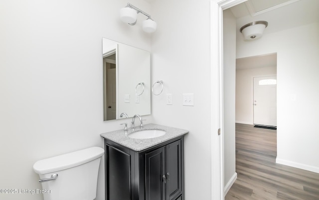 bathroom featuring hardwood / wood-style flooring, vanity, and toilet