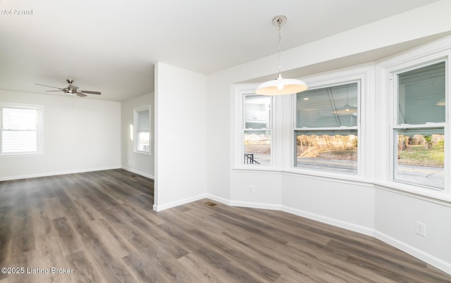 unfurnished room with dark hardwood / wood-style floors and ceiling fan