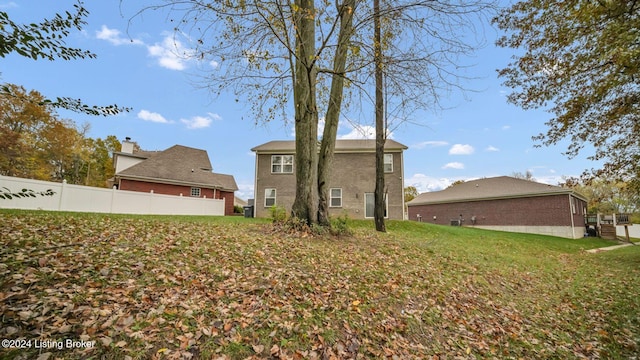 rear view of house with a yard