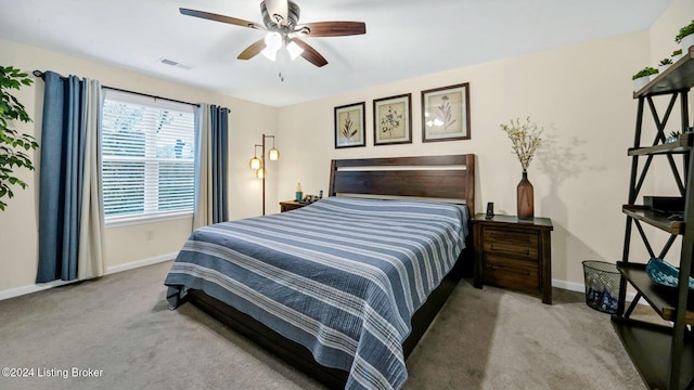 bedroom with light carpet and ceiling fan