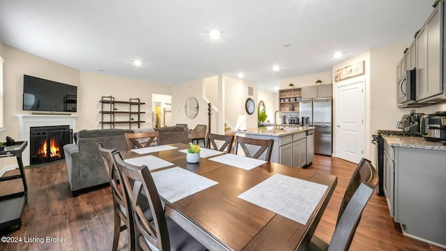 dining room featuring sink and dark hardwood / wood-style flooring