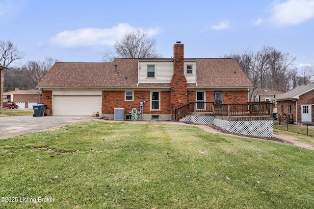 rear view of property featuring a garage, a deck, central AC unit, and a lawn