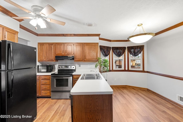 kitchen featuring sink, black refrigerator, ornamental molding, stainless steel electric range oven, and light wood-type flooring