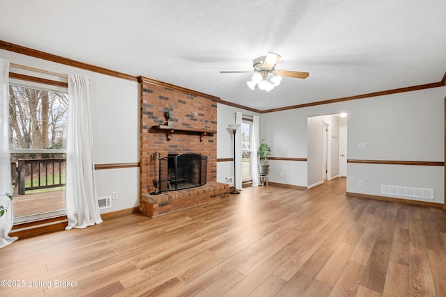 unfurnished living room featuring a fireplace, light hardwood / wood-style flooring, ornamental molding, and a textured ceiling