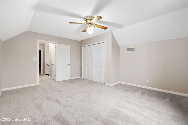 additional living space with lofted ceiling, light colored carpet, and ceiling fan