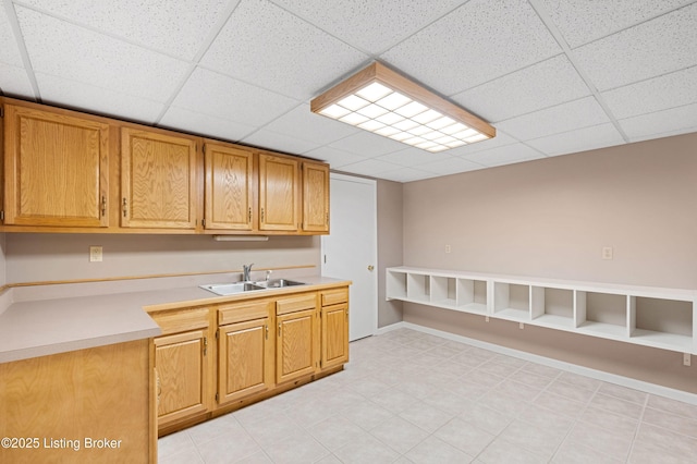 kitchen featuring a paneled ceiling and sink