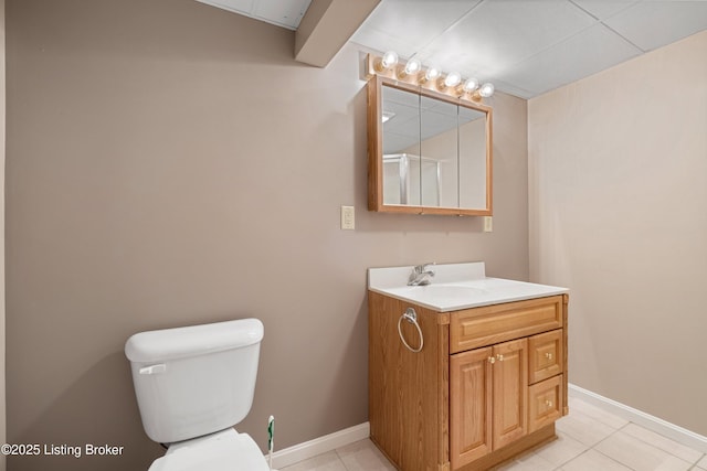 bathroom featuring vanity, tile patterned flooring, and toilet