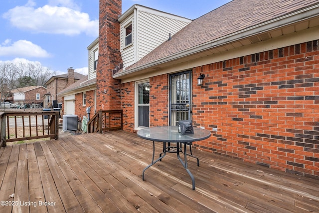 deck featuring a garage and central air condition unit