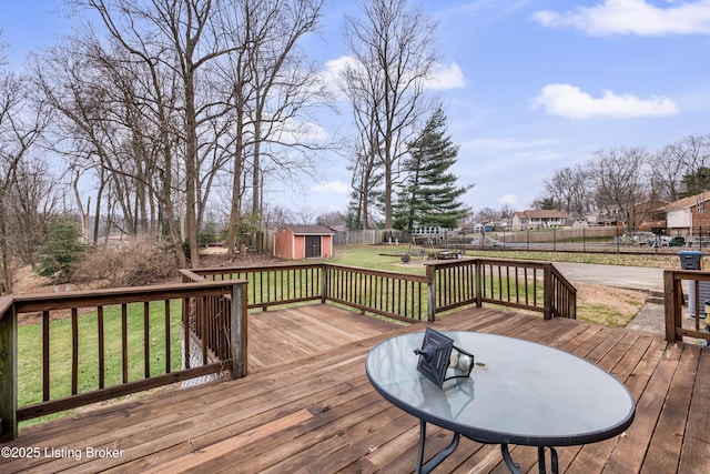 wooden deck featuring a yard and a storage shed