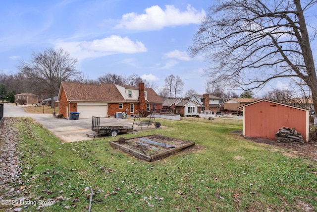 view of yard with a wooden deck, a storage shed, and a garage