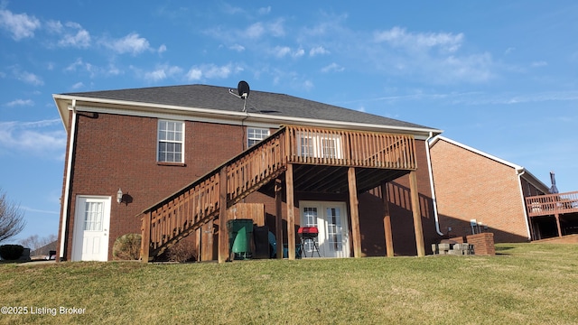 rear view of property featuring a wooden deck and a lawn