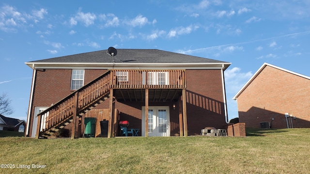 back of house featuring central AC, a deck, and a lawn