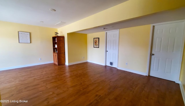 empty room featuring dark hardwood / wood-style flooring