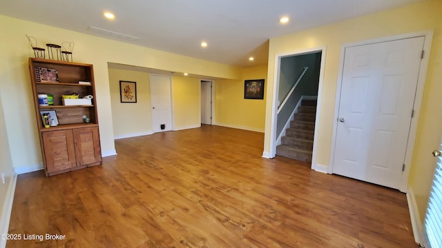 unfurnished living room with wood-type flooring