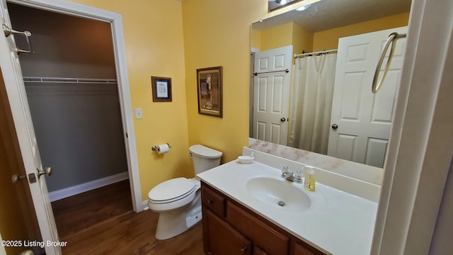 bathroom with hardwood / wood-style flooring, vanity, and toilet