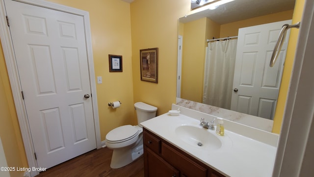 bathroom with vanity, hardwood / wood-style floors, and toilet