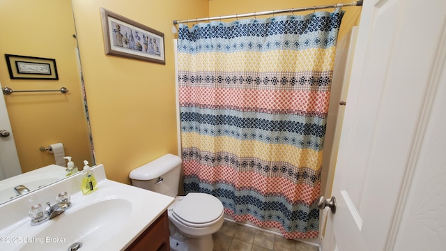 bathroom with walk in shower, vanity, toilet, and tile patterned flooring