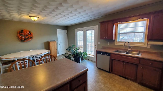 kitchen with dishwasher, sink, and crown molding