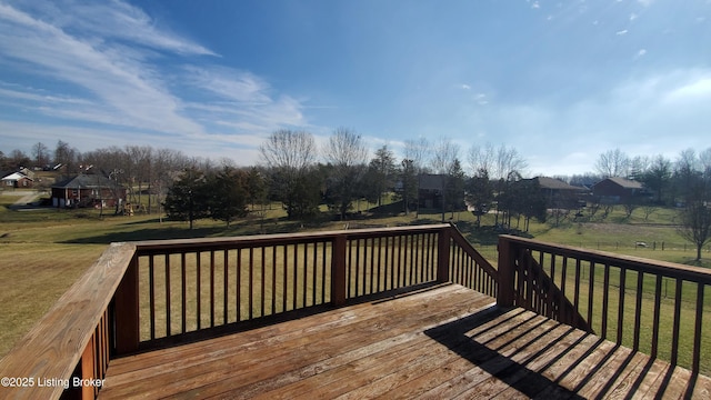 wooden terrace featuring a yard