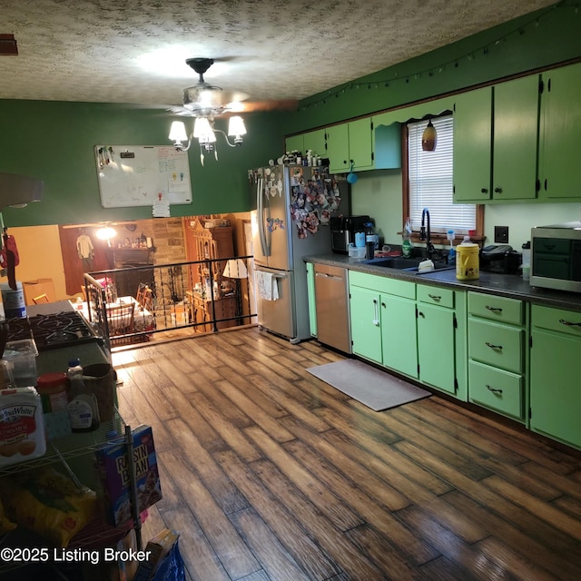 kitchen featuring green cabinets, stainless steel appliances, dark hardwood / wood-style floors, and sink