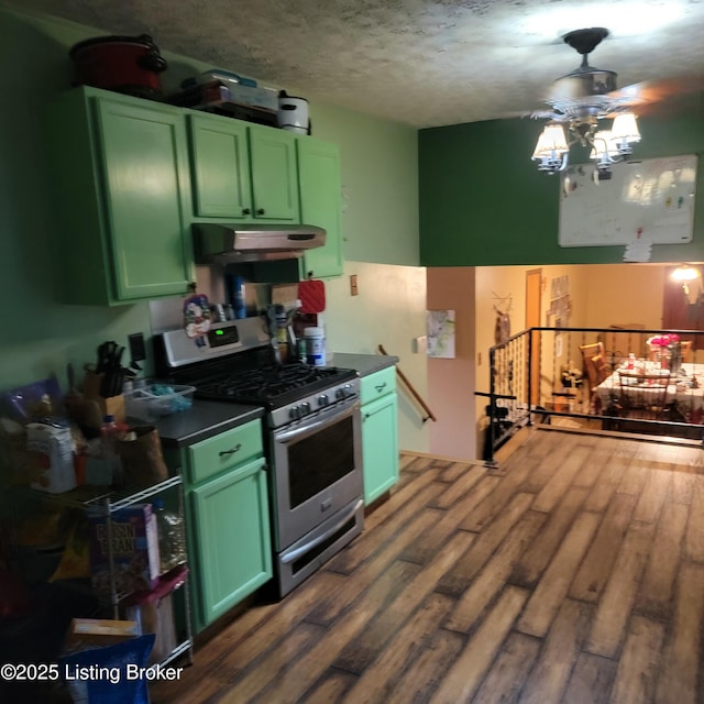 kitchen featuring green cabinetry, dark hardwood / wood-style flooring, stainless steel gas range, and a textured ceiling