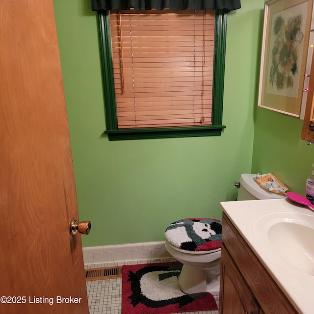 bathroom with vanity, toilet, and tile patterned flooring