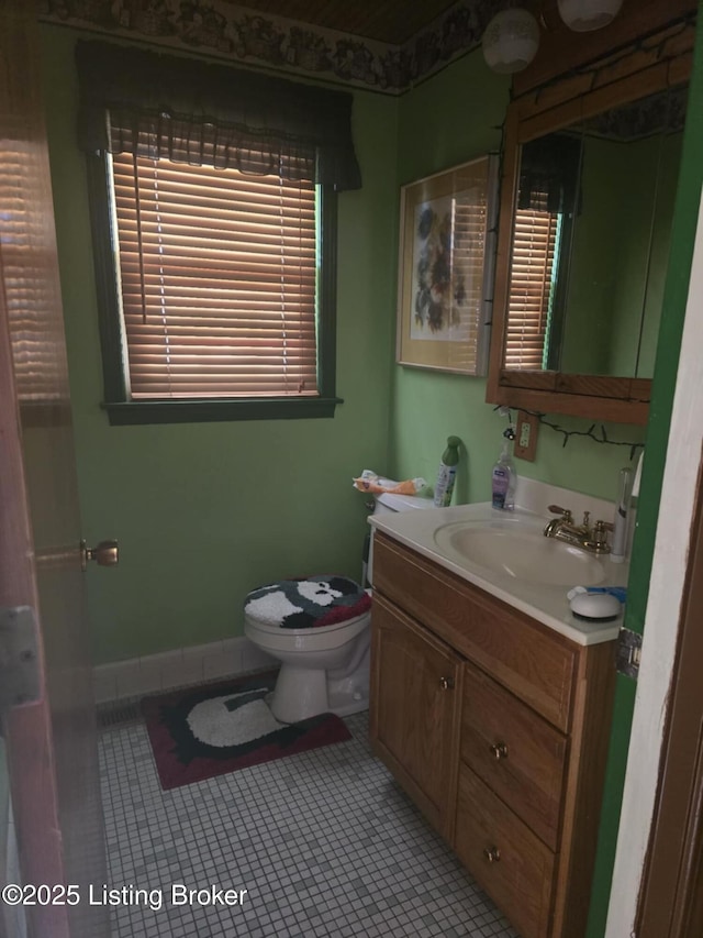 bathroom with vanity, toilet, and tile patterned flooring