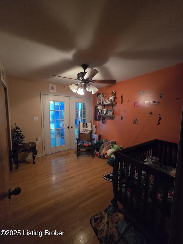 bedroom featuring hardwood / wood-style flooring, ceiling fan, and french doors