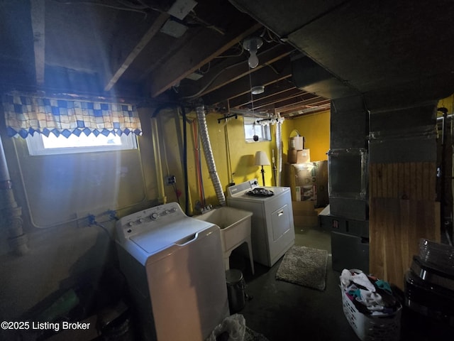 clothes washing area with sink and independent washer and dryer