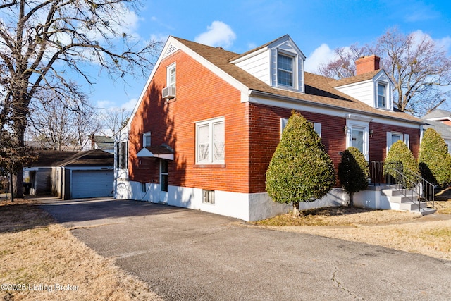 view of front of home featuring an outbuilding, cooling unit, and a garage