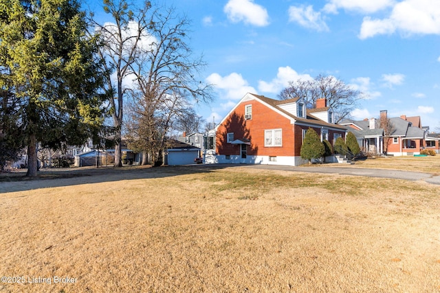 view of side of home with a yard and a garage