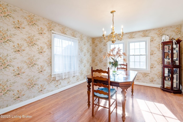 dining room featuring a notable chandelier, hardwood / wood-style floors, and a wealth of natural light