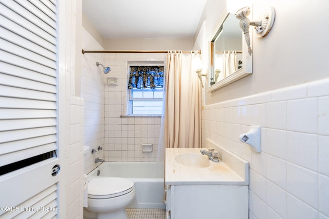 full bathroom with vanity, tile walls, shower / bath combination with curtain, and toilet