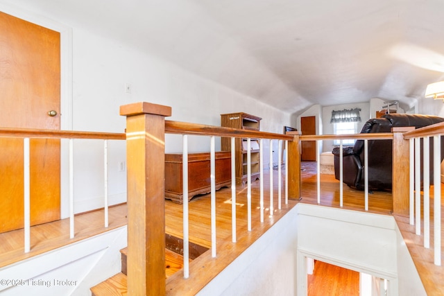 corridor featuring lofted ceiling and wood-type flooring