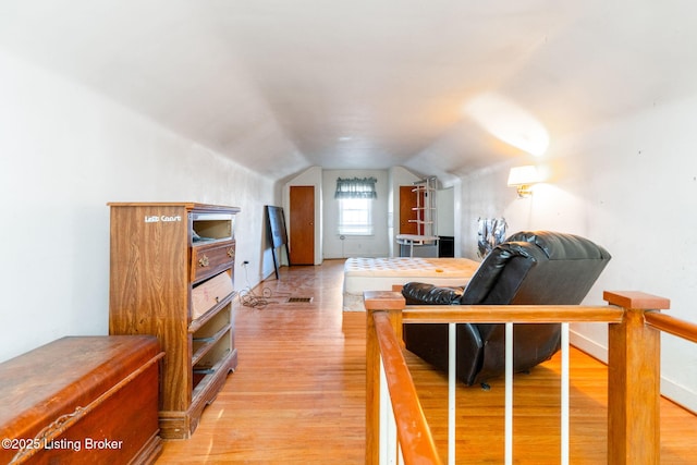 living room with vaulted ceiling and light hardwood / wood-style flooring