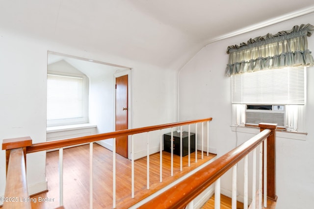 corridor featuring hardwood / wood-style floors and vaulted ceiling