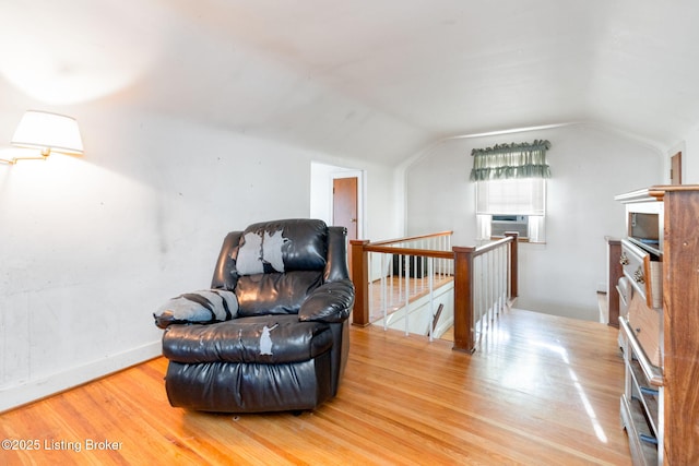 sitting room with lofted ceiling and light wood-type flooring