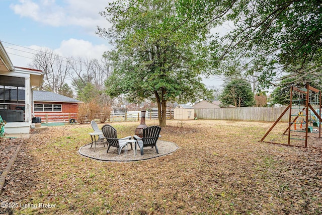 view of yard featuring a shed and a playground