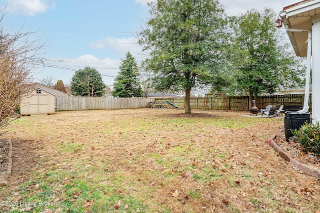 view of yard featuring an outdoor fire pit and a storage shed