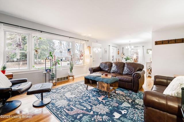 living room with hardwood / wood-style floors and a chandelier