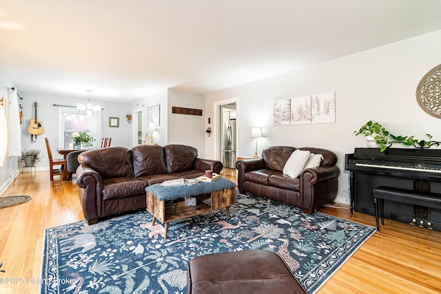 living room with wood-type flooring and a chandelier