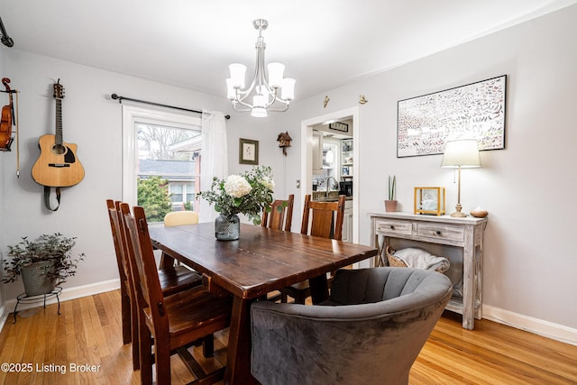 dining space featuring a chandelier and light hardwood / wood-style flooring