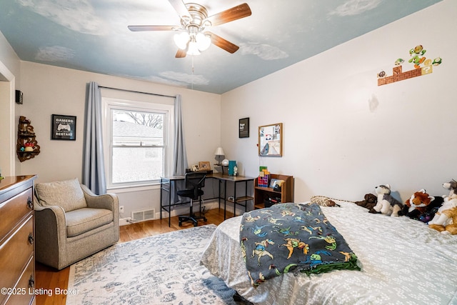 bedroom with wood-type flooring and ceiling fan