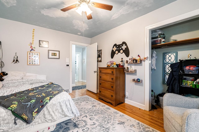 bedroom with ceiling fan and light hardwood / wood-style floors