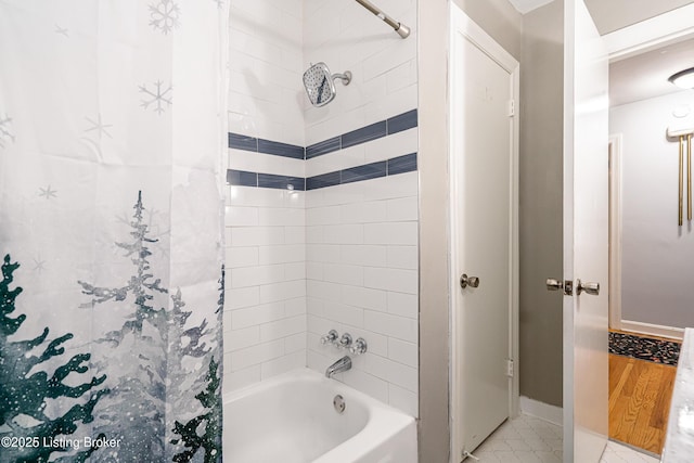 bathroom with shower / tub combo with curtain and tile patterned flooring