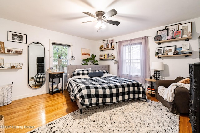 bedroom with ceiling fan and hardwood / wood-style floors